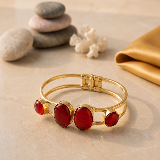 Gold bracelet with red gems