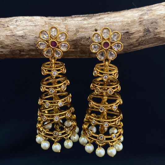 Gold earrings with floral design and pearl drops.
